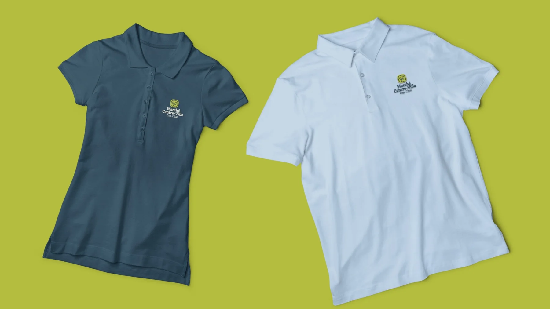 Deux polos, l’un bleu foncé, l’autre blanc, portant le logo du Marché Centre-Ville sur fond vert lime.